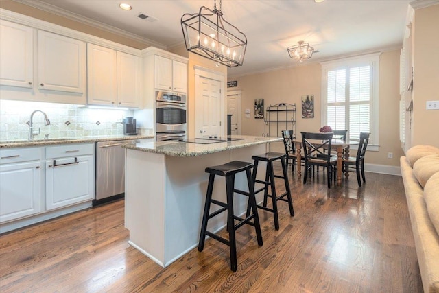 1506 Wolf Bend Rd, Germantown, TN 38138 - kitchen featuring dishwasher, ornamental molding, backsplash, dark wood-type flooring, and a breakfast bar
