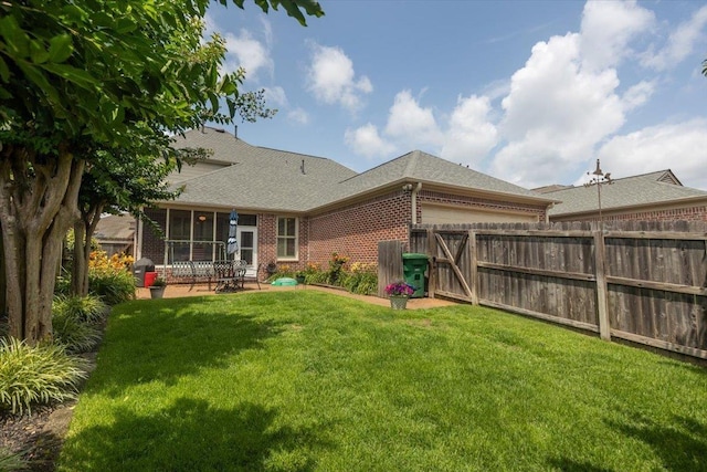 1506 Wolf Bend Rd, Germantown, TN 38138 - back of property with brick siding, roof with shingles, a garage, and a sunroom