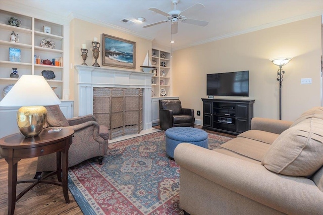 1506 Wolf Bend Rd, Germantown, TN 38138 - living area featuring wood finished floors, built in features, a fireplace with flush hearth, a ceiling fan, and ornamental molding