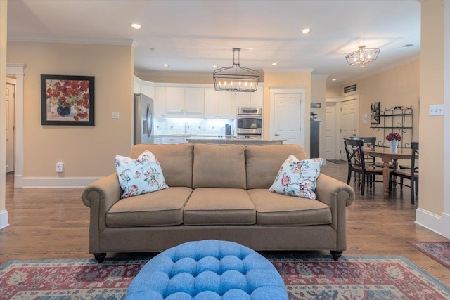1506 Wolf Bend Rd, Germantown, TN 38138 - living area featuring a chandelier, wood finished floors, recessed lighting, and ornamental molding