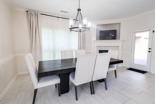 8510 Wolf Trace Ln, Bartlett, TN 38133 - dining area with a chandelier, a fireplace, and crown molding