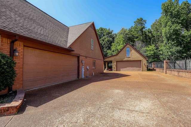 8510 Wolf Trace Ln, Bartlett, TN 38133 - view of home's exterior featuring a garage, brick siding, and roof with shingles