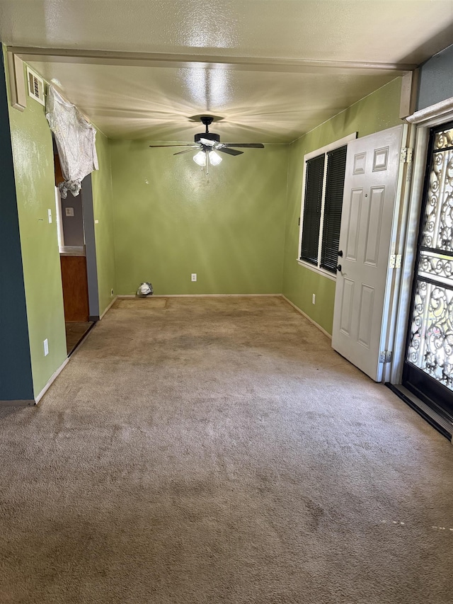 1493 Ragan St, Memphis, TN 38106 - unfurnished living room with carpet flooring and a ceiling fan