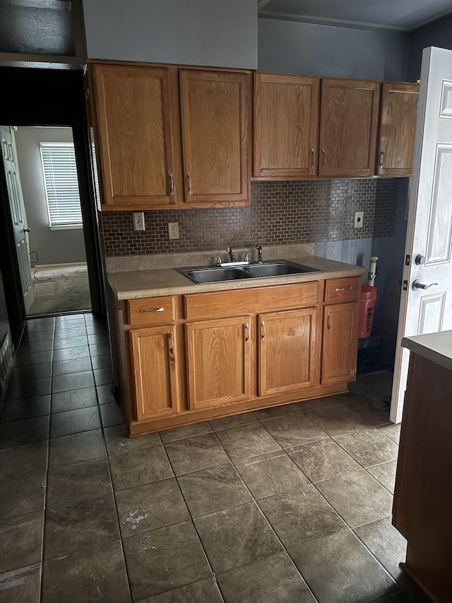 1493 Ragan St, Memphis, TN 38106 - kitchen with brown cabinets, light countertops, and tasteful backsplash