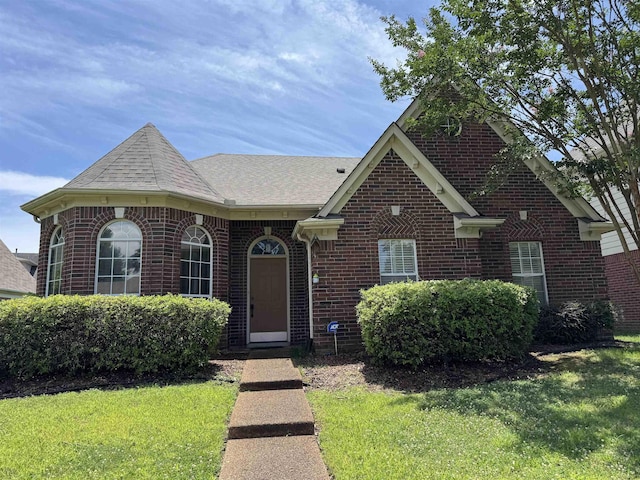 850 N Ericson Rd, Memphis, TN 38018 - view of front of property with brick siding, a front yard, and roof with shingles