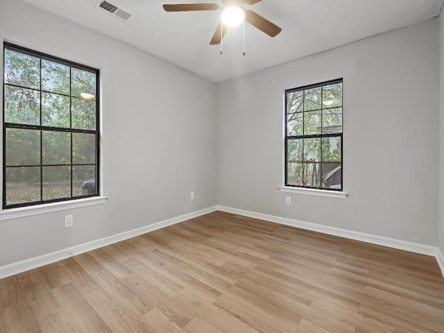 1438 Silver St, Memphis, TN 38106 - spare room featuring healthy amount of natural light, light wood-type flooring, and ceiling fan