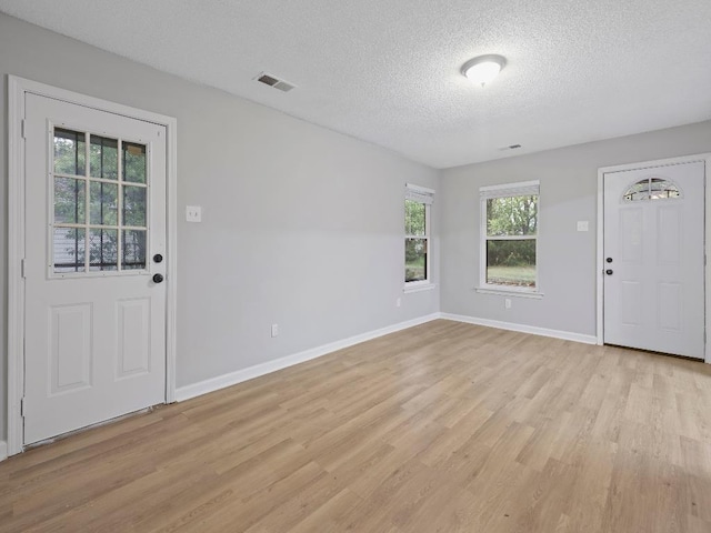 1438 Silver St, Memphis, TN 38106 - foyer entrance with a textured ceiling and light wood-style flooring