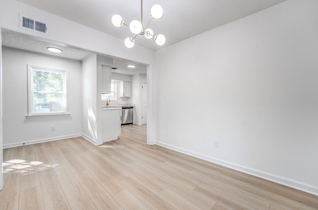 3693 Socorro Cv, Memphis, TN 38128 - unfurnished living room with light wood finished floors and a chandelier