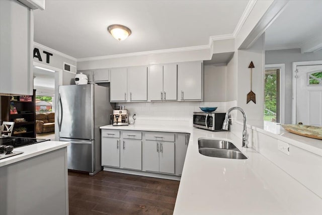 4583 E Dearing Rd, Memphis, TN 38117 - kitchen featuring appliances with stainless steel finishes, crown molding, light countertops, dark wood-style flooring, and decorative backsplash
