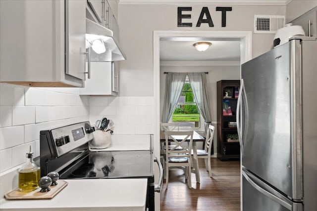 4583 E Dearing Rd, Memphis, TN 38117 - kitchen with appliances with stainless steel finishes, crown molding, under cabinet range hood, backsplash, and dark wood-style floors