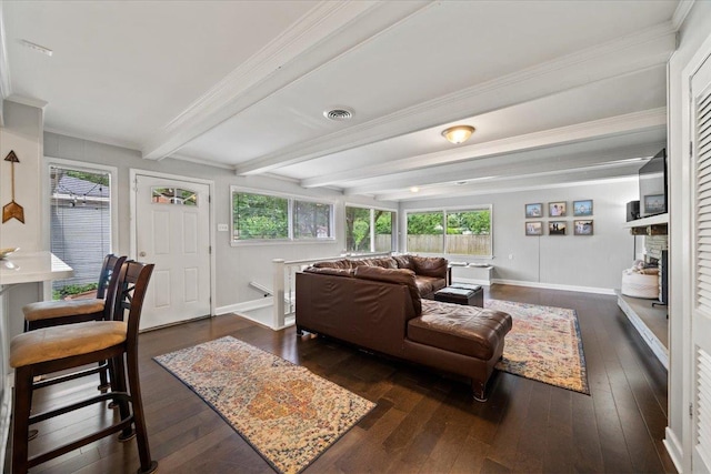 4583 E Dearing Rd, Memphis, TN 38117 - living area featuring dark wood-type flooring, beamed ceiling, crown molding, and a stone fireplace