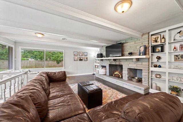 4583 E Dearing Rd, Memphis, TN 38117 - living area with a stone fireplace, beam ceiling, wood finished floors, and ornamental molding