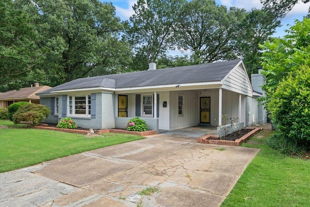 4583 E Dearing Rd, Memphis, TN 38117 - ranch-style house with a chimney, a front yard, concrete driveway, a carport, and board and batten siding