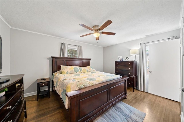 4583 E Dearing Rd, Memphis, TN 38117 - bedroom with dark wood finished floors, ornamental molding, a textured ceiling, and ceiling fan