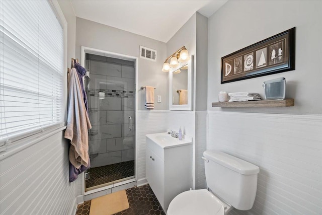 4583 E Dearing Rd, Memphis, TN 38117 - full bath featuring vanity, a stall shower, wainscoting, tile walls, and tile patterned flooring