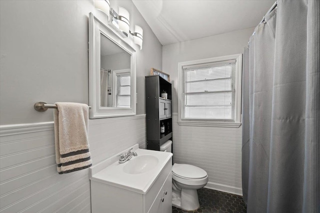 4583 E Dearing Rd, Memphis, TN 38117 - bathroom with vanity, tile walls, a wainscoted wall, tile patterned floors, and a shower with curtain