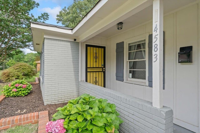 4583 E Dearing Rd, Memphis, TN 38117 - view of exterior entry with board and batten siding, brick siding, and covered porch