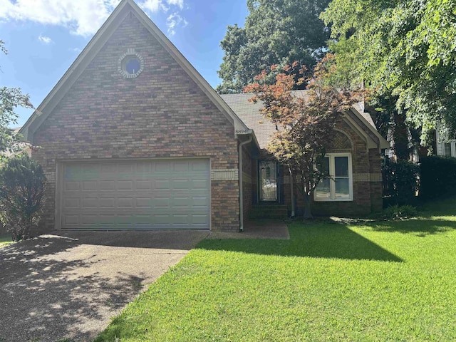 8894 Lake Edge Cv, Memphis, TN 38016 - view of front of property featuring a garage, a front lawn, driveway, and brick siding