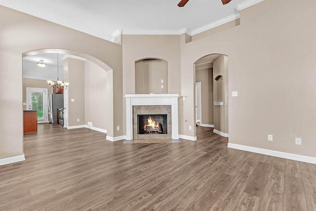 6836 Lagrange Grove Dr, Cordova, TN 38018 - unfurnished living room featuring ornamental molding, a ceiling fan, wood finished floors, a tiled fireplace, and a chandelier