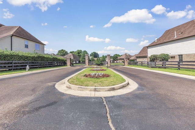 6836 Lagrange Grove Dr, Cordova, TN 38018 - view of asphalt street featuring curbs, a gated entry, and a gate