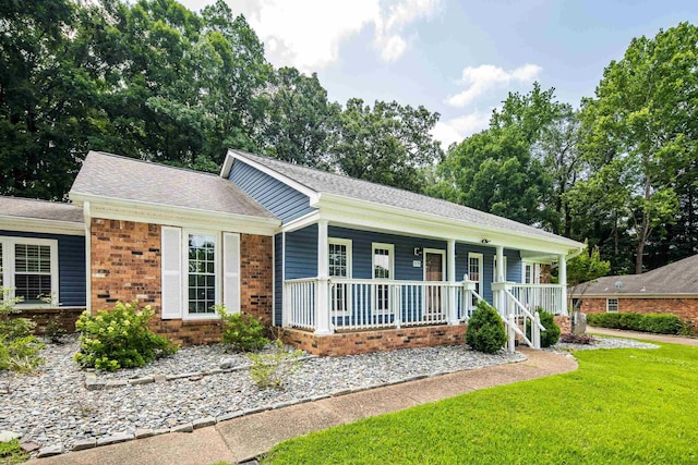 2270 Atherstone Pl, Memphis, TN 38016 - ranch-style home with a porch, a front lawn, brick siding, and roof with shingles