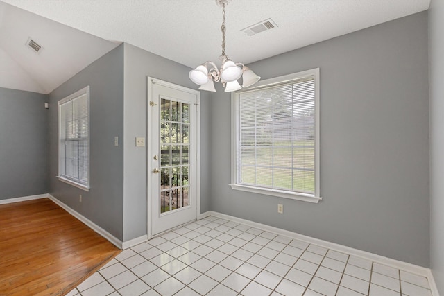 2766 Fletcher View Dr, Memphis, TN 38016 - unfurnished dining area with a chandelier, light wood finished floors, and vaulted ceiling