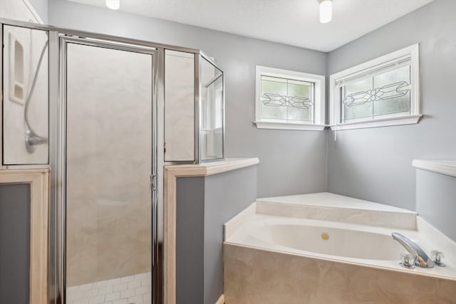 2766 Fletcher View Dr, Memphis, TN 38016 - bathroom featuring a bath, a shower stall, and a textured ceiling
