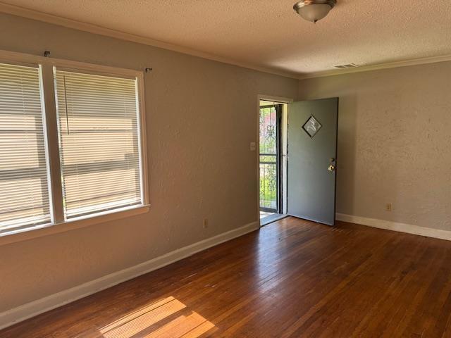 1827 S Orleans Ave, Memphis, TN 38106 - spare room featuring ornamental molding, a textured ceiling, and wood finished floors