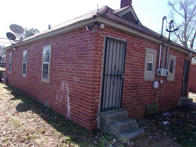 2606 Deadrick Ave, Memphis, TN 38114 - view of property exterior featuring entry steps, brick siding, and a chimney