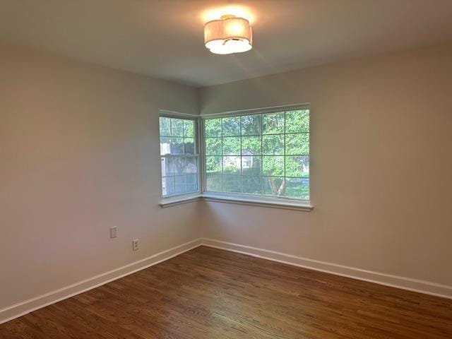 118 N Highland St N, Memphis, TN 38111 - spare room with baseboards and dark wood-style flooring