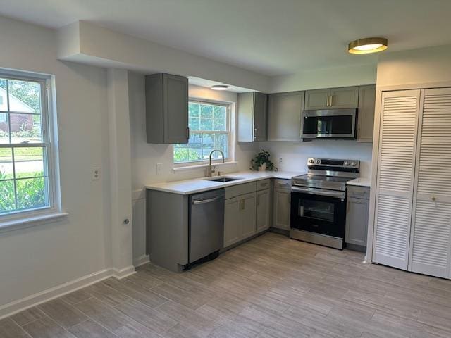 118 N Highland St N, Memphis, TN 38111 - kitchen with stainless steel appliances, gray cabinetry, and light countertops