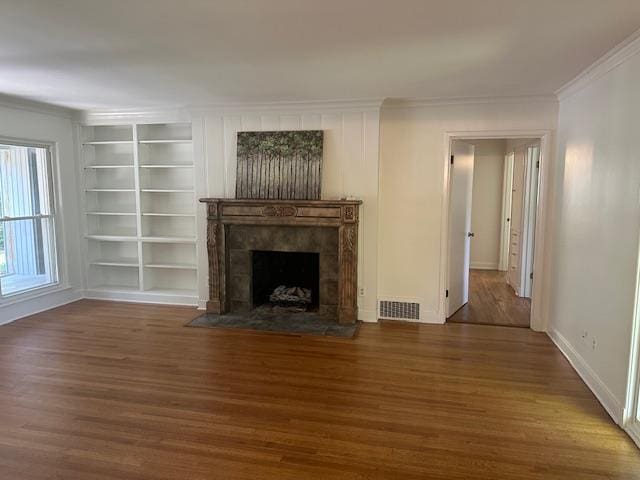 118 N Highland St N, Memphis, TN 38111 - unfurnished living room featuring crown molding, wood finished floors, a fireplace, and built in features