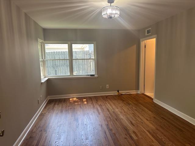 118 N Highland St N, Memphis, TN 38111 - empty room with dark wood-type flooring and a chandelier