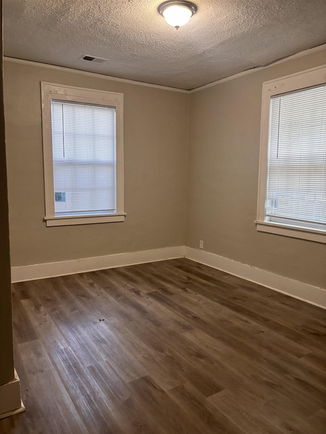 1043 Pearce St, Memphis, TN 38107 - spare room with a textured ceiling, healthy amount of natural light, and dark wood-type flooring