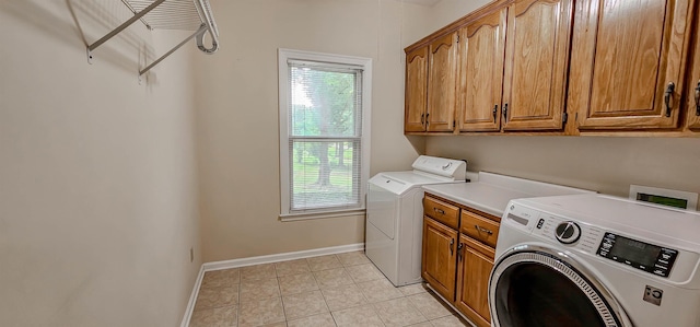 4030 Windolyn Way, Bartlett, TN 38133 - washroom featuring cabinet space, light tile patterned floors, and washer and dryer