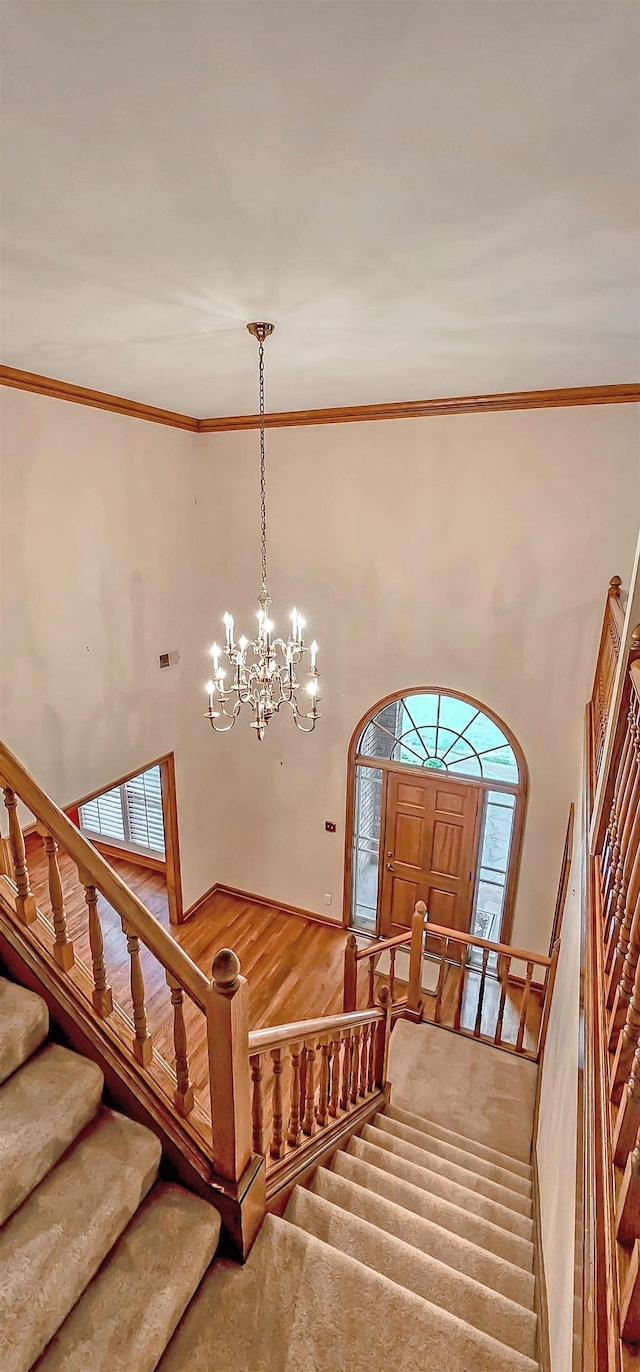 4030 Windolyn Way, Bartlett, TN 38133 - stairs with a towering ceiling, crown molding, and a chandelier