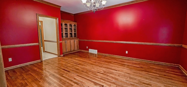 4030 Windolyn Way, Bartlett, TN 38133 - empty room featuring a chandelier, wood finished floors, and ornamental molding