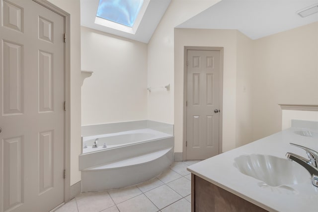 4532 Quail Flight Cv, Memphis, TN 38141 - bathroom with a skylight, double vanity, a bath, and tile patterned flooring