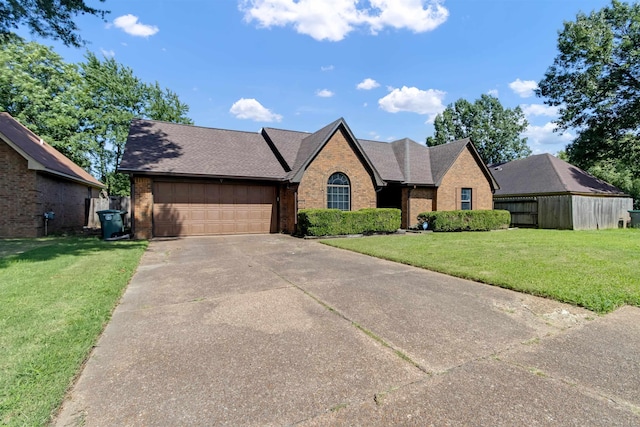 4532 Quail Flight Cv, Memphis, TN 38141 - view of front facade featuring brick siding, a front yard, a garage, and concrete driveway