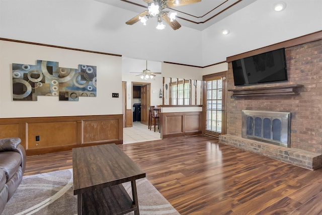 4532 Quail Flight Cv, Memphis, TN 38141 - living area featuring a ceiling fan, light wood-style flooring, a wainscoted wall, a brick fireplace, and recessed lighting