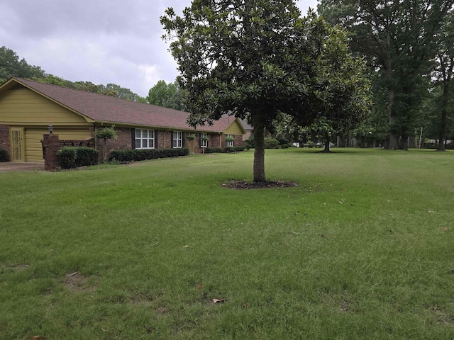 8355 Craven Rd, Bartlett, TN 38002 - view of green lawn featuring an attached garage