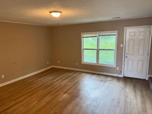 3816 Cedar Path Dr, Memphis, TN 38115 - empty room featuring a textured ceiling, wood finished floors, and crown molding