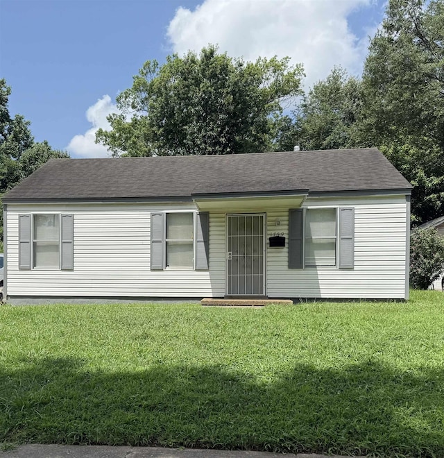 1759 Walter St, Memphis, TN 38108 - view of front of house with a front yard and roof with shingles