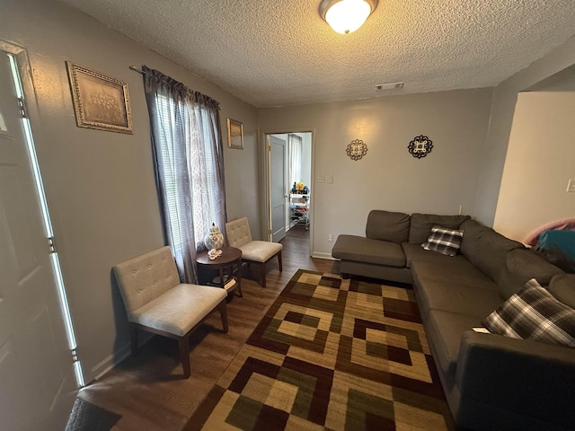 1759 Walter St, Memphis, TN 38108 - living area with a textured ceiling and dark wood-style flooring