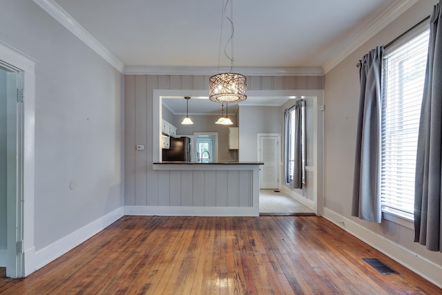 699 New York St, Memphis, TN 38104 - unfurnished living room featuring wood-type flooring and ornamental molding