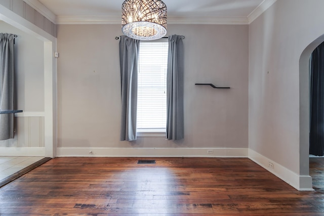 699 New York St, Memphis, TN 38104 - spare room featuring arched walkways, wood-type flooring, a chandelier, and crown molding