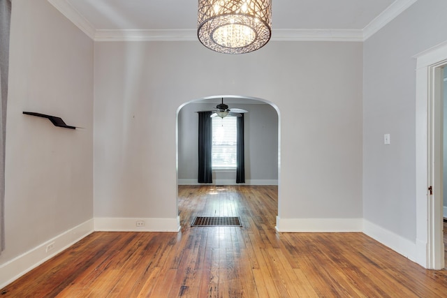 699 New York St, Memphis, TN 38104 - entryway with arched walkways, wood-type flooring, ornamental molding, and a chandelier