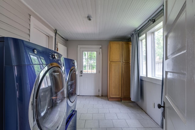 699 New York St, Memphis, TN 38104 - laundry room featuring washer and dryer, cabinet space, and light tile patterned flooring