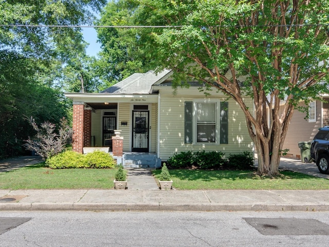 699 New York St, Memphis, TN 38104 - view of front of home with a front lawn and covered porch