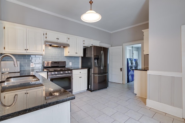 699 New York St, Memphis, TN 38104 - kitchen featuring stainless steel appliances, under cabinet range hood, washer and dryer, crown molding, and tasteful backsplash